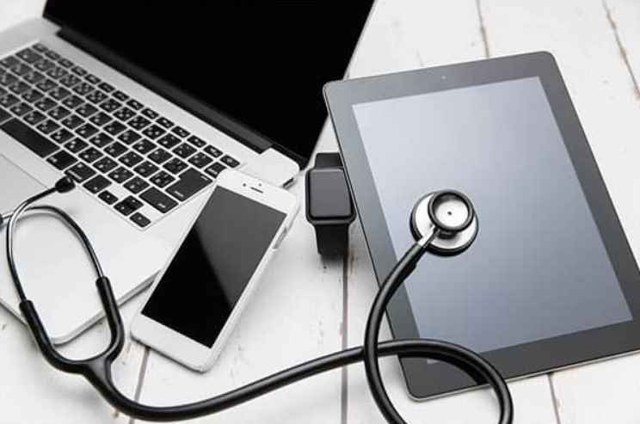 Laptop, phone and tablet with a stethoscope for computer maintenance